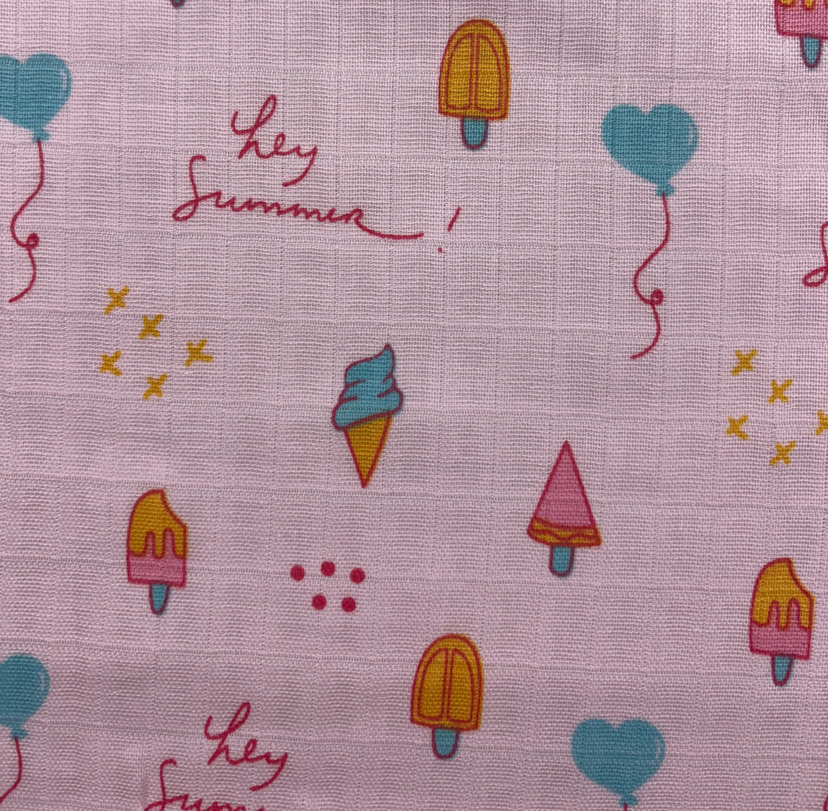 A close-up of colorful printed muslin fabric draped elegantly, highlighting its soft texture and intricate designs.