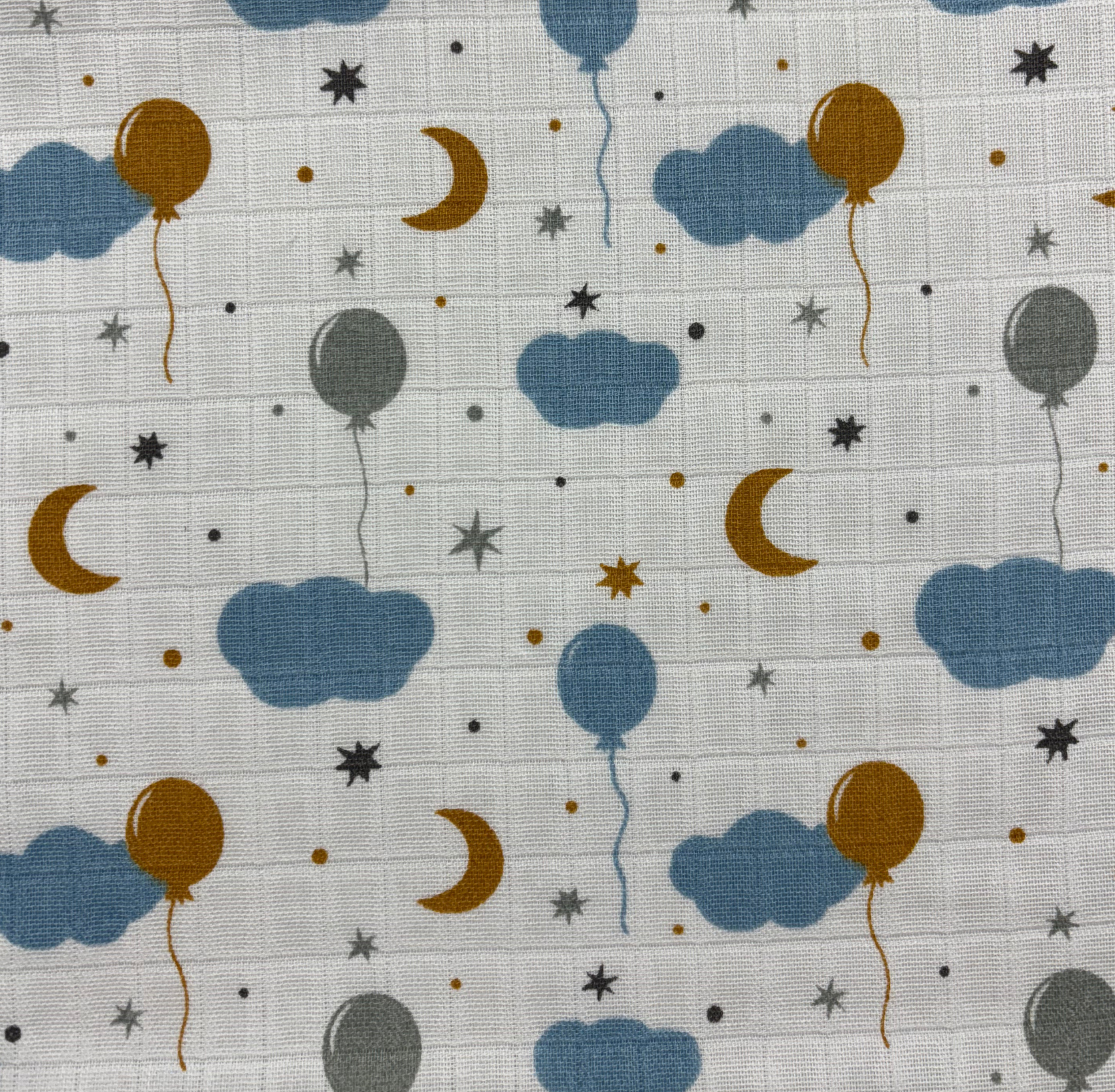 A collection of printed muslin fabrics in pastel colors, perfect for crafting children's clothing and nursery decor.