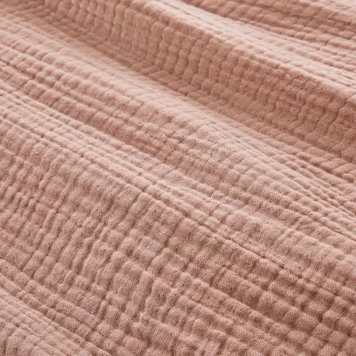 A collection of crushed muslin cloth in various colors, showcasing its textured surface and versatility for fashion and home decor.