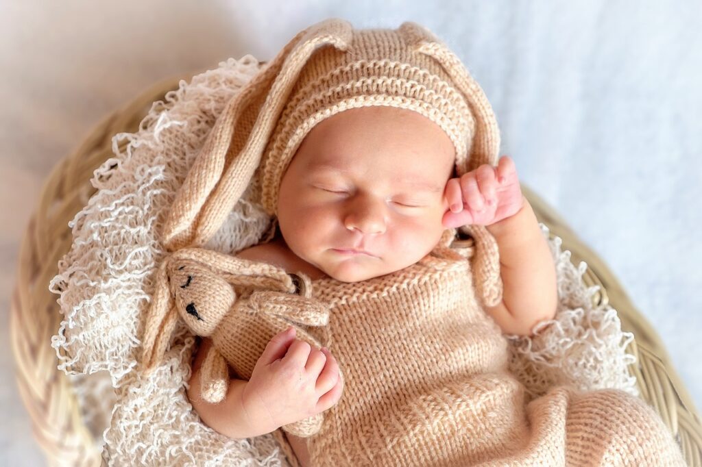 A collection of adorable infant and kids' essentials made from soft muslin fabric, including swaddles, blankets, and clothing, showcasing the fabric's gentle texture and breathable qualities.