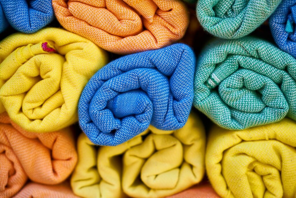 An engaging visual of the dyeing process for muslin fabric, showcasing vibrant dye baths and the transformation of plain muslin into colorful textiles.