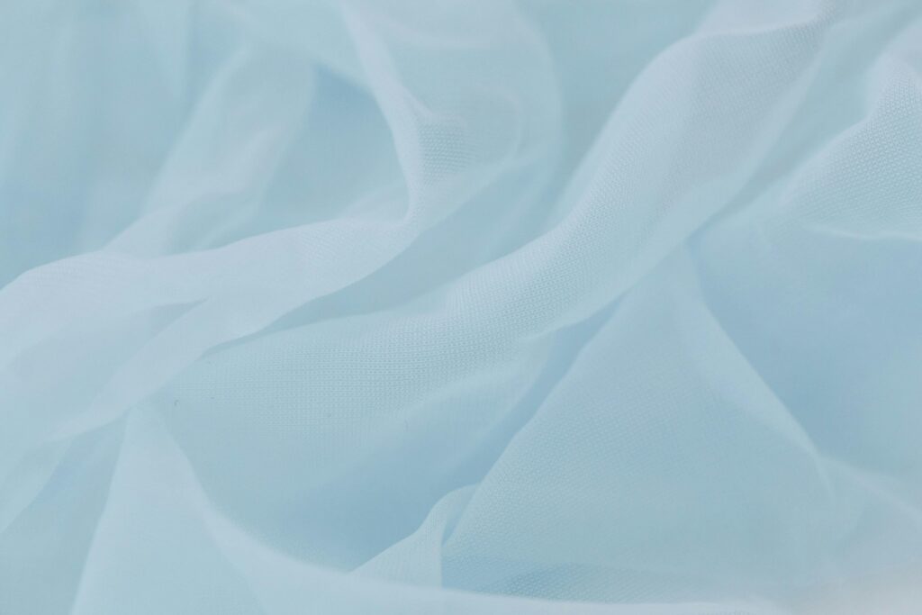 Close-up image of various fabric swatches showcasing different textures, including cotton, silk, and polyester.